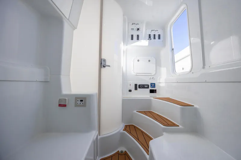  Yacht Photos Pics Interior of 2017 Yellowfin 42 Offshore boat with white walls and wooden steps.