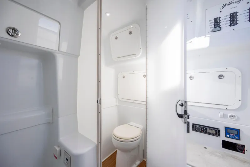  Yacht Photos Pics 2017 Yellowfin 42 Offshore boat bathroom with modern fixtures and white interior.