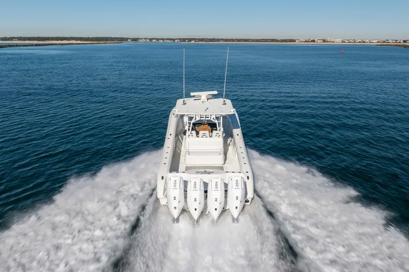  Yacht Photos Pics 2017 Yellowfin 42 Offshore boat cruising on open water with four engines.
