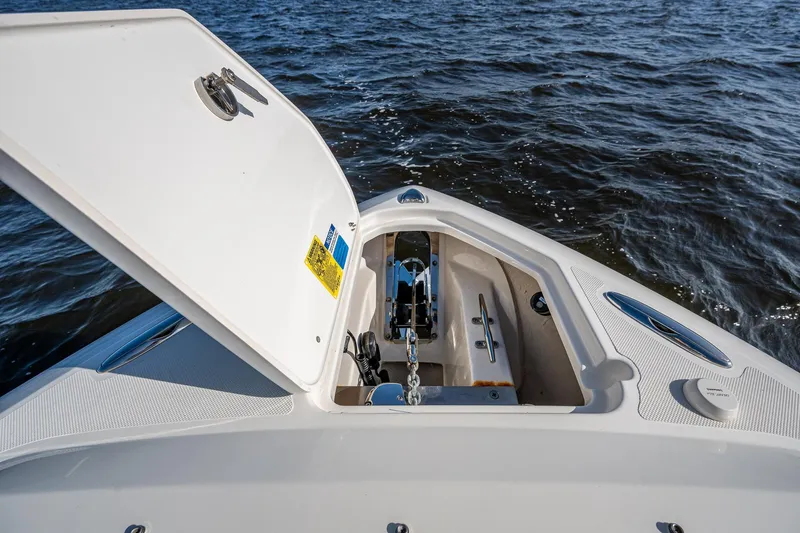  Yacht Photos Pics 2021 Pursuit DC 266 Dual Console boat anchor compartment open on water.