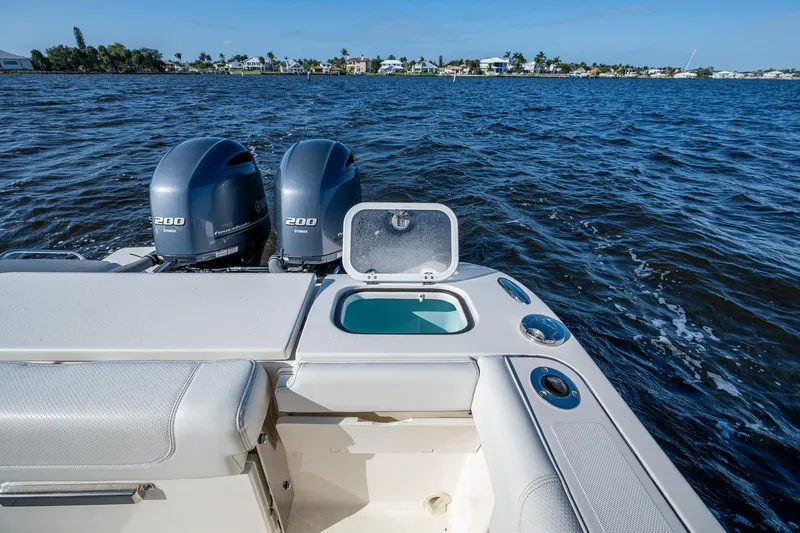  Yacht Photos Pics 2021 Pursuit DC 266 Dual Console boat with twin engines on open water.