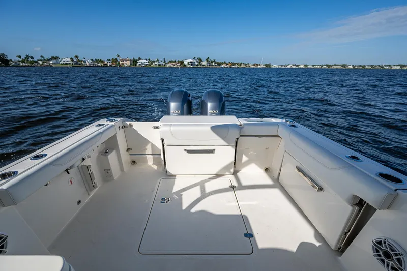  Yacht Photos Pics 2021 Pursuit DC 266 Dual Console boat on open water, featuring spacious deck and twin engines.