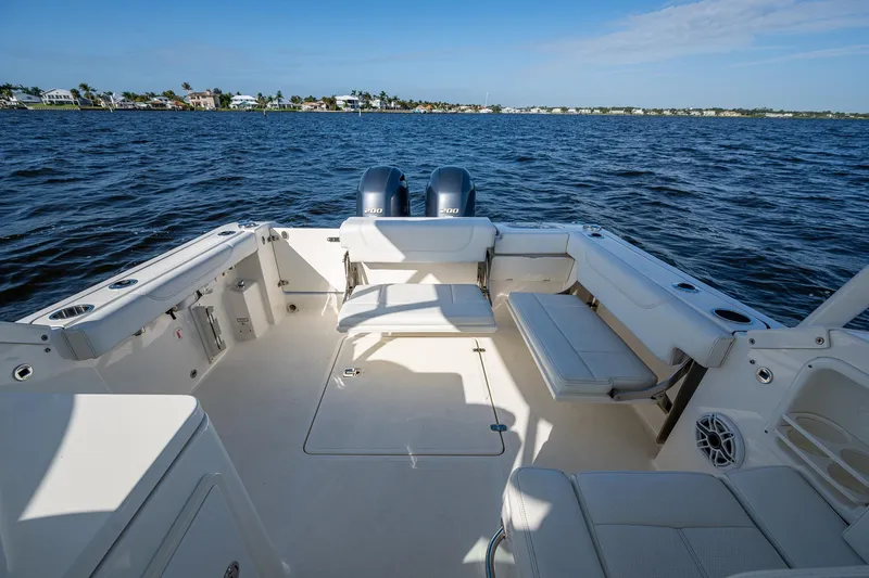  Yacht Photos Pics 2021 Pursuit DC 266 Dual Console boat on open water, featuring spacious seating.