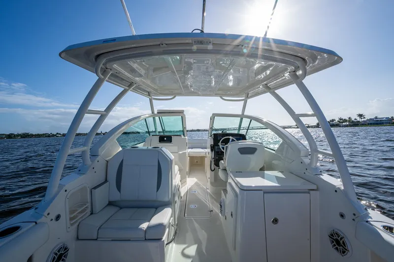  Yacht Photos Pics 2021 Pursuit DC 266 Dual Console boat interior on sunny day, ocean view.