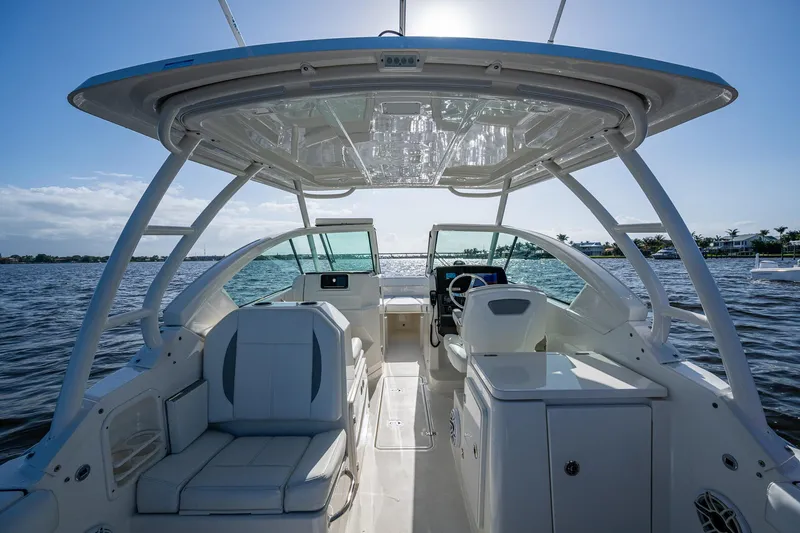  Yacht Photos Pics 2021 Pursuit DC 266 Dual Console boat interior on open water, featuring seating and helm.