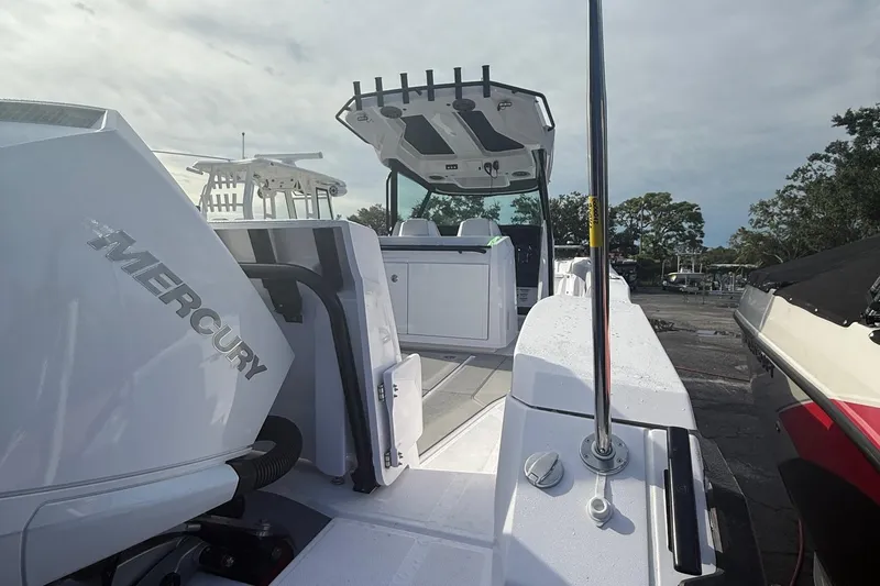  Yacht Photos Pics 2025 Axopar 29 CCX boat with Mercury engine, docked outdoors.