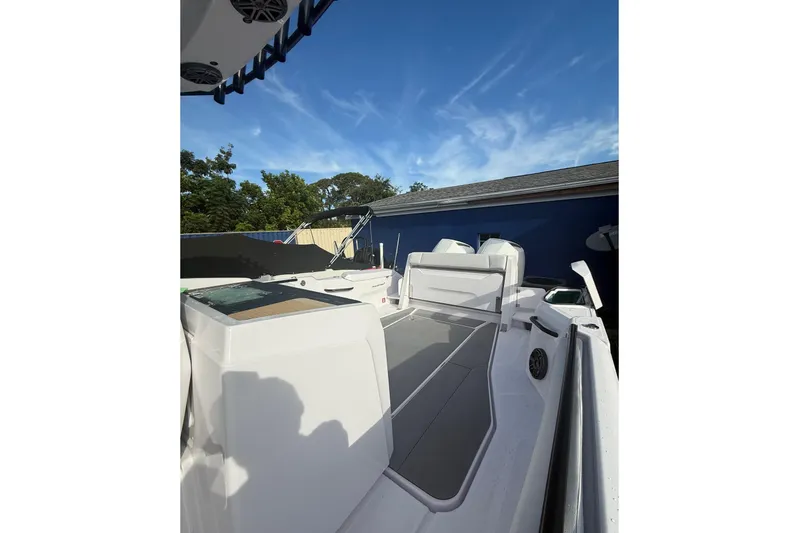  Yacht Photos Pics 2025 Axopar 29 CCX boat deck with seating, under clear blue sky.
