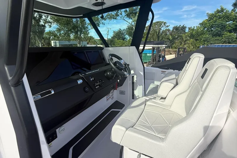  Yacht Photos Pics 2025 Axopar 29 CCX boat interior with modern helm and comfortable seating.