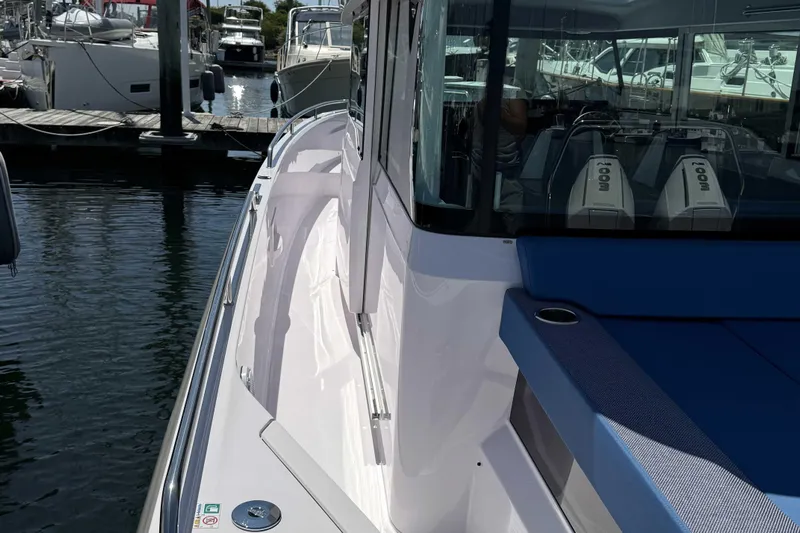  Yacht Photos Pics 2024 Axopar 37 XC CROSS CABIN boat docked, showcasing sleek design and modern features.