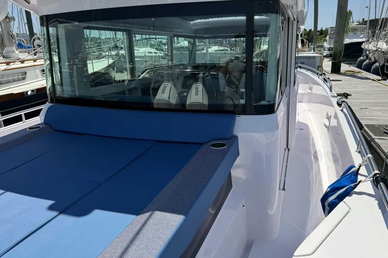  Yacht Photos Pics 2024 Axopar 37 XC CROSS CABIN boat with blue seating and modern design.