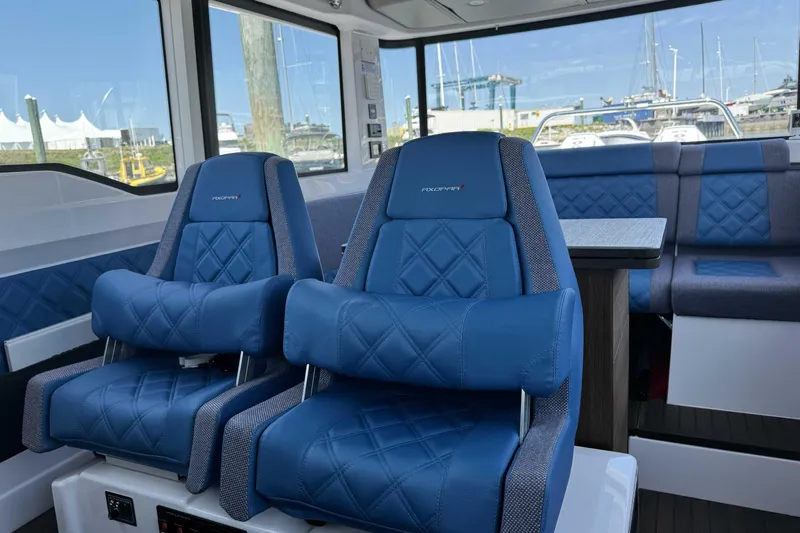  Yacht Photos Pics 2024 Axopar 37 XC CROSS CABIN interior with blue seating and modern design.