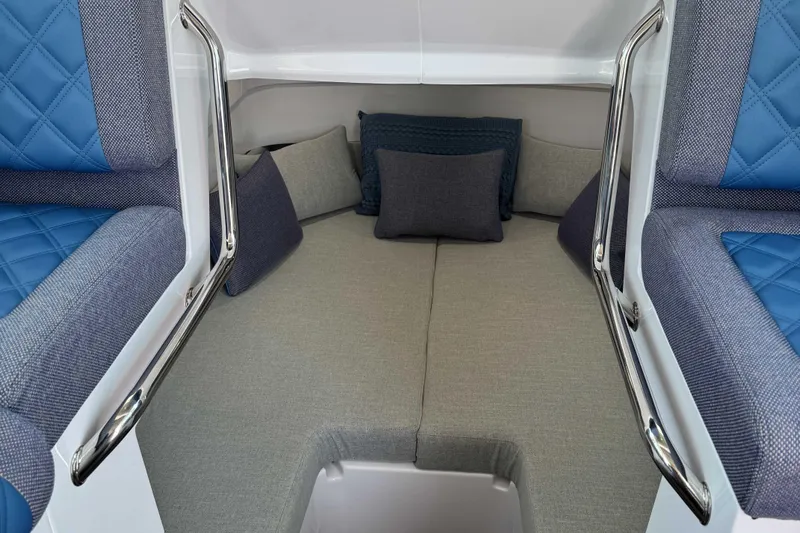  Yacht Photos Pics 2024 Axopar 37 XC CROSS CABIN interior with blue and gray seating and cushions.