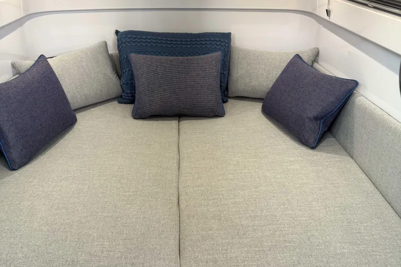  Yacht Photos Pics 2024 Axopar 37 XC CROSS CABIN interior with cozy gray and blue cushions.