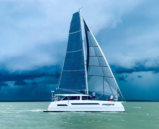 Windsurfer Yacht Photos Pics Sailing yacht Max Cruise 44SC 2022 on stormy sea with dramatic sky.