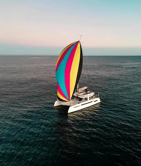 Windsurfer Yacht Photos Pics Colorful sailboat, Custom Max Cruise 44SC 2022, sailing on calm ocean waters.