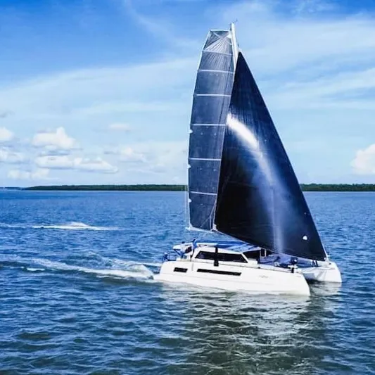 Windsurfer Yacht Photos Pics Custom Max Cruise 44SC 2022 catamaran sailing on open water under clear blue skies.