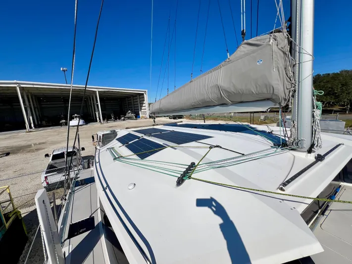Windsurfer Yacht Photos Pics Custom Max Cruise 44SC 2022 sailboat with solar panels, docked near storage facility.
