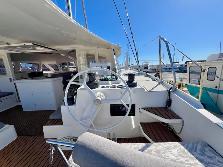 Windsurfer Yacht Photos Pics Custom Max Cruise 44SC 2022 yacht cockpit with steering wheel and seating, docked in marina.