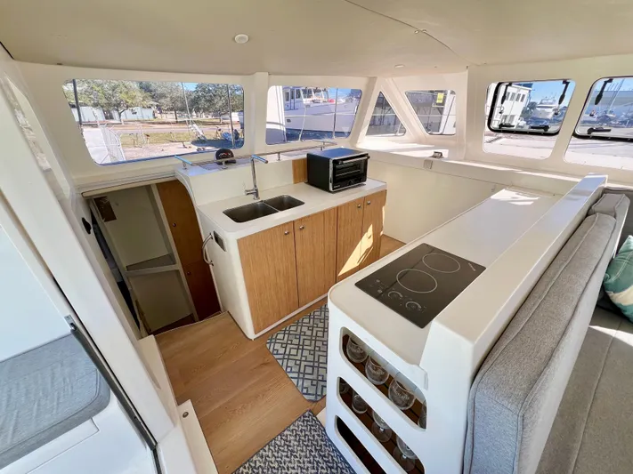 Windsurfer Yacht Photos Pics Interior of 2022 Custom Max Cruise 44SC yacht with modern kitchen and seating area.