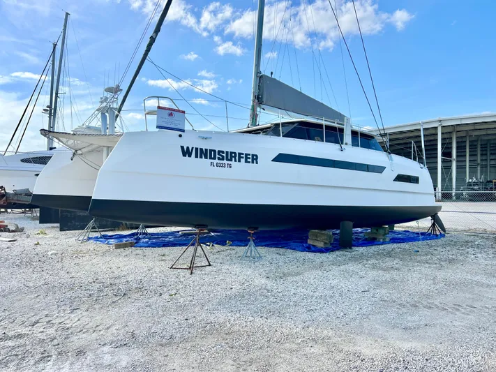 Windsurfer Yacht Photos Pics 2022 Max Cruise Marine 44SC catamaran on land, named "Windsurfer," under a clear blue sky.