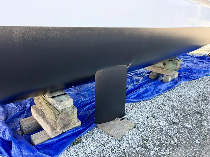 Windsurfer Yacht Photos Pics Max Cruise Marine 44SC 2022 boat hull on wooden supports, blue tarp underneath.