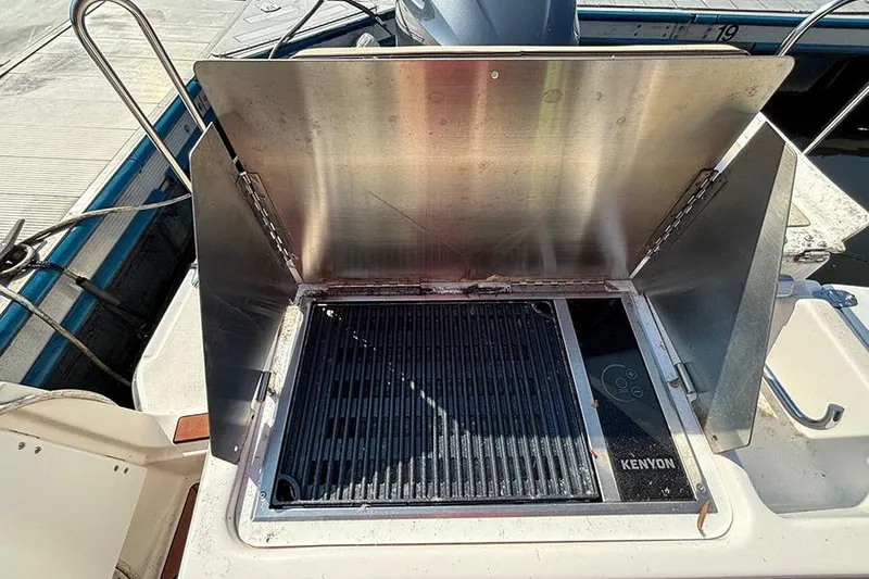  Yacht Photos Pics Outdoor grill on 2021 Ranger Tugs R-27 boat, featuring Kenyon cooking surface.