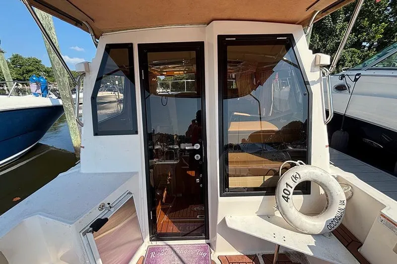  Yacht Photos Pics 2021 Ranger Tugs R-27 boat stern view with glass doors and life ring.
