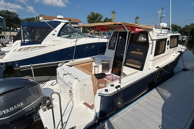  Yacht Photos Pics 2021 Ranger Tugs R-27 boat docked, featuring Yamaha engine and spacious deck area.