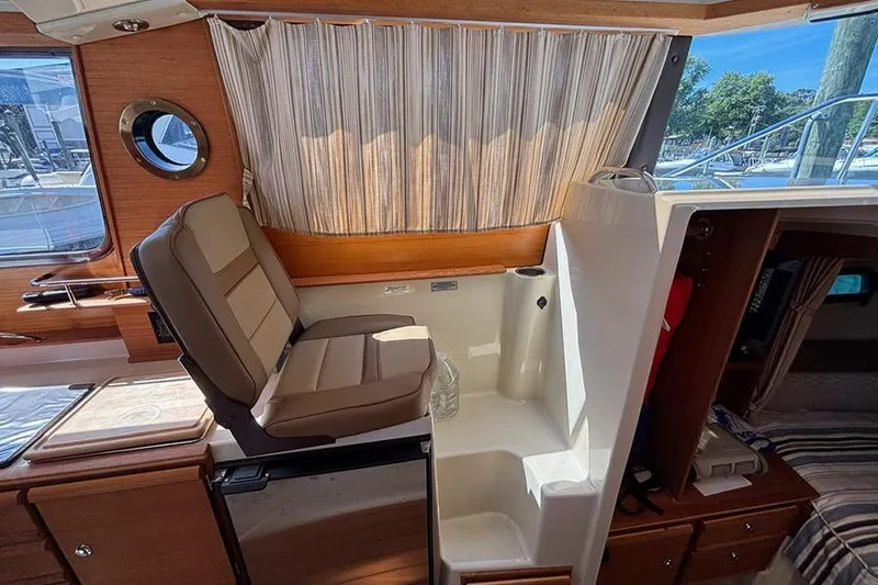  Yacht Photos Pics Interior of 2021 Ranger Tugs R-27 boat with seating and window view.