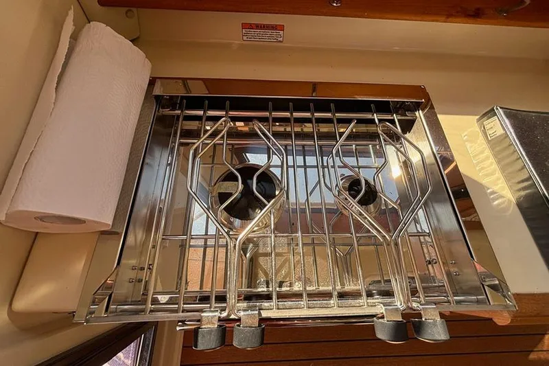  Yacht Photos Pics 2021 Ranger Tugs R-27 boat kitchen with stainless steel stove and paper towel holder.