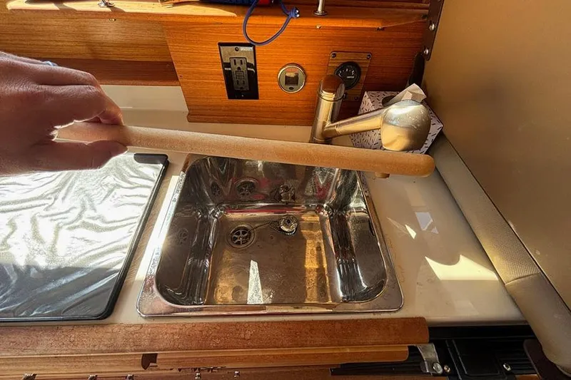  Yacht Photos Pics 2021 Ranger Tugs R-27 kitchen sink area with wooden countertop and faucet.