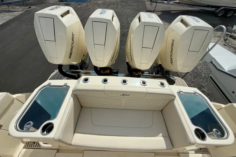  Yacht Photos Pics 2026 Scout 400 LXF Li-Ion boat with four Mercury outboard engines, rear seating, and storage compartments.