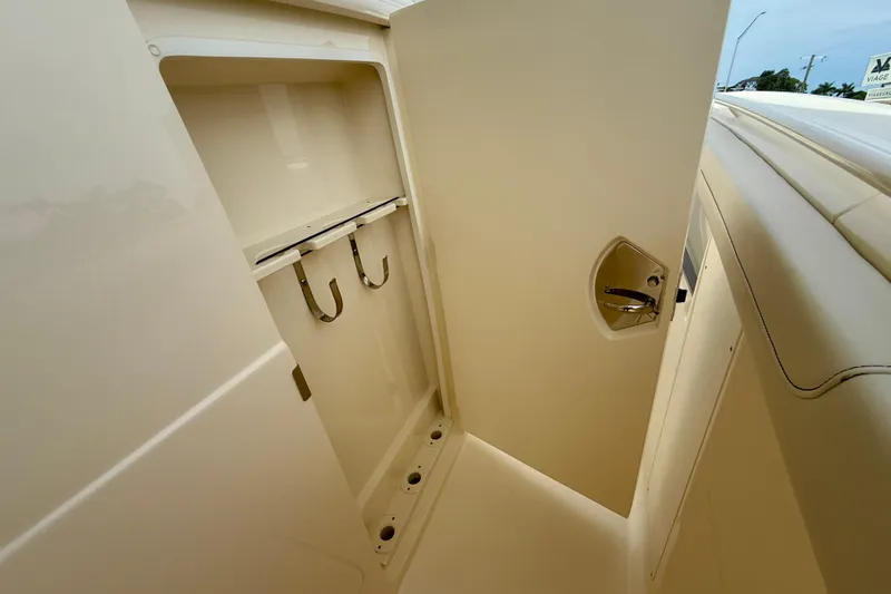  Yacht Photos Pics 2026 Scout 400 LXF Li-Ion boat storage compartment with hooks and sleek design.