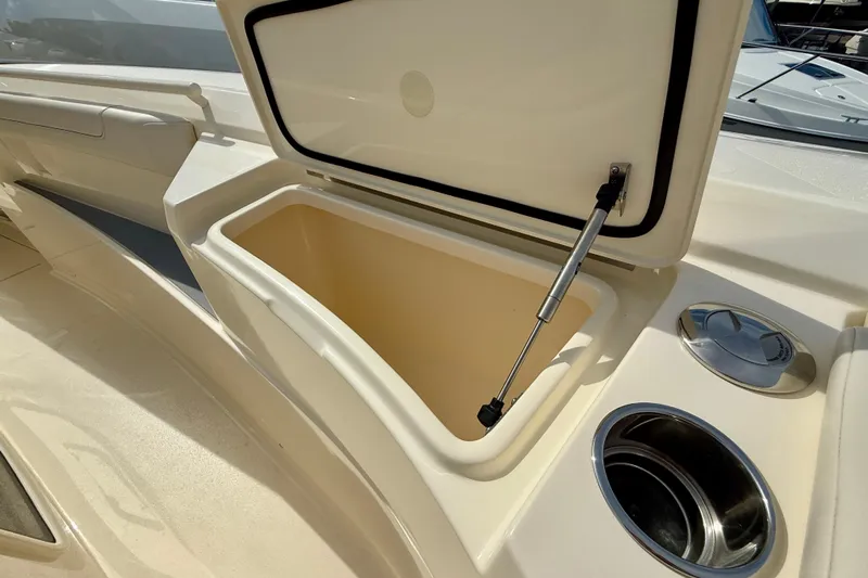  Yacht Photos Pics Open storage compartment on 2026 Scout 400 LXF Li-Ion boat with cup holders.