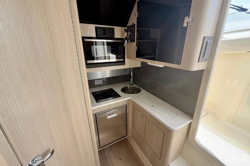  Yacht Photos Pics Modern kitchen in 2026 Scout 400 LXF Li-Ion boat with microwave and sink.