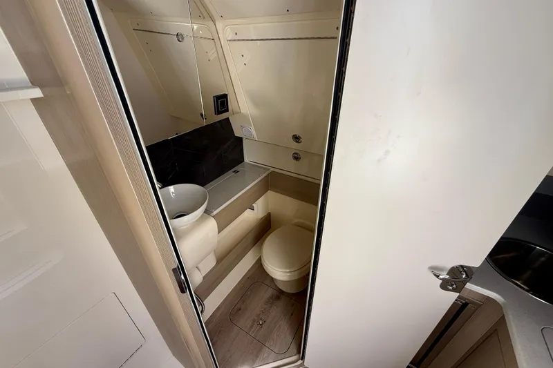  Yacht Photos Pics Compact bathroom interior of 2026 Scout 400 LXF Li-Ion boat, featuring modern fixtures.