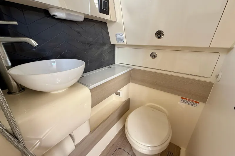  Yacht Photos Pics Luxurious bathroom in 2026 Scout 400 LXF Li-Ion boat with modern fixtures and sleek design.