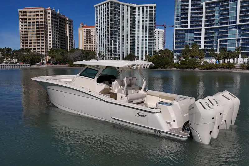  Yacht Photos Pics 2026 Scout 400 LXF Li-Ion boat on calm water with city skyline backdrop.