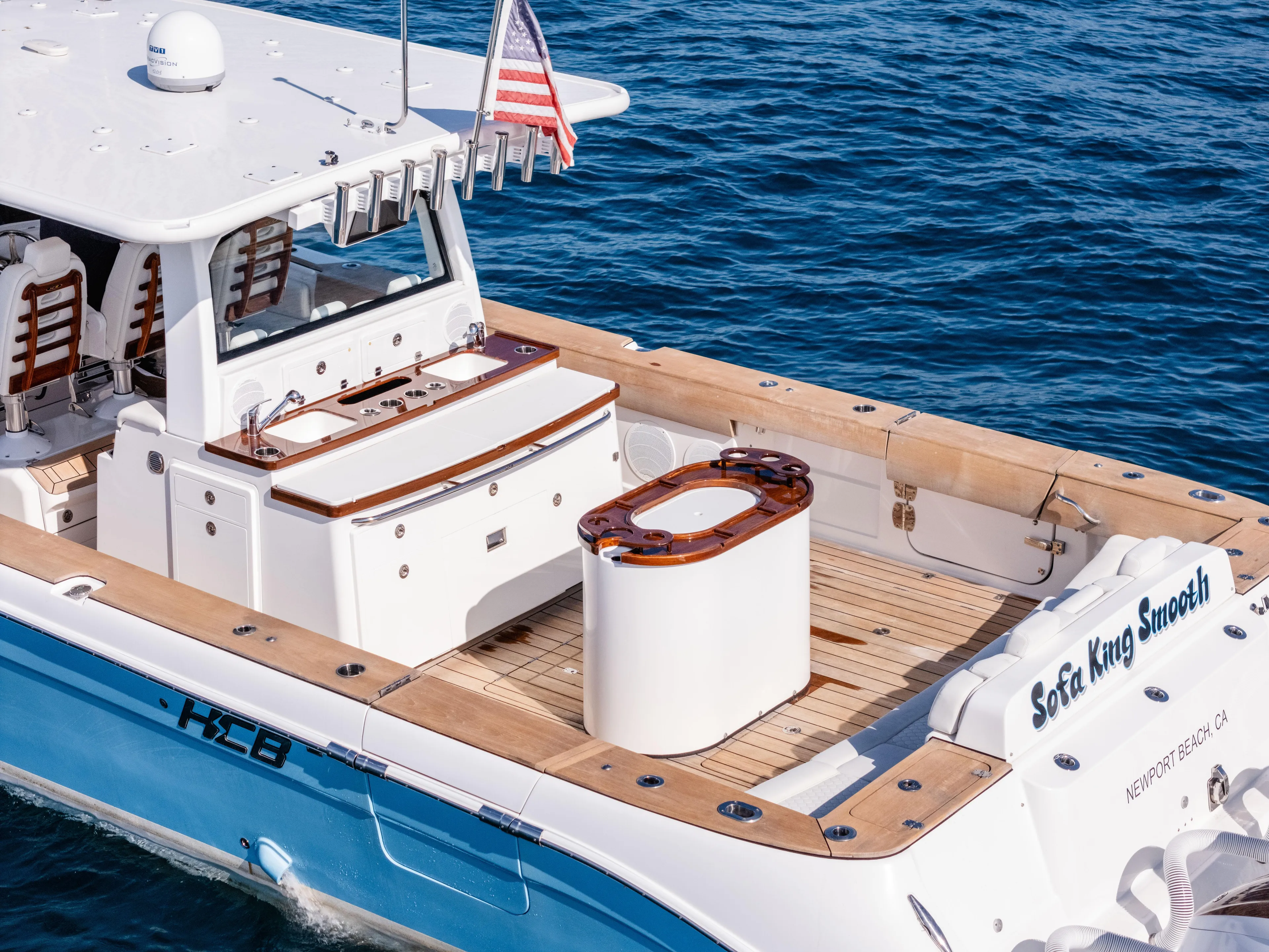  Yacht Photos Pics 2020 HCB 53 Sueños boat on water, featuring spacious deck and American flag.