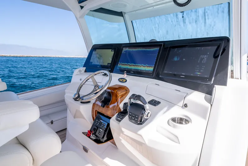  Yacht Photos Pics HCB 53 Sueños 2020 boat helm with advanced navigation displays on open water.