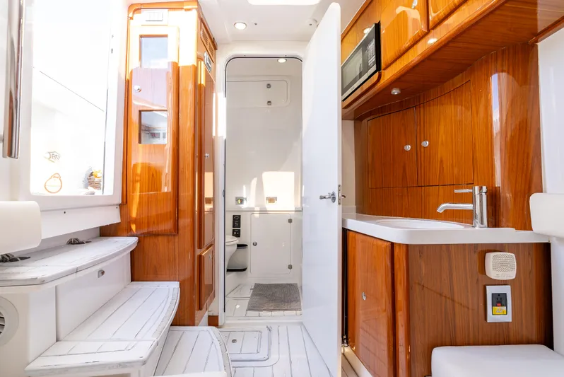  Yacht Photos Pics Luxurious interior of 2020 HCB 53 Sueños yacht with wooden cabinetry and modern amenities.