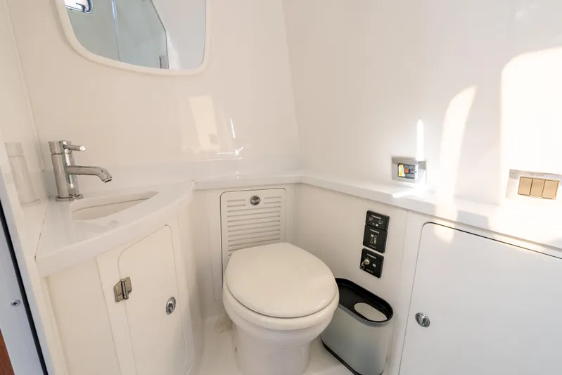  Yacht Photos Pics 2020 HCB 53 Sueños boat bathroom with modern fixtures and white interior.