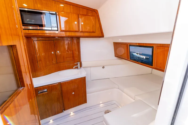  Yacht Photos Pics Luxurious interior of 2020 HCB 53 Sueños yacht with wood cabinetry and seating.