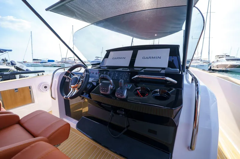 Pardo 38 Yacht Photos Pics 2025 Pardo Yachts P38 helm with Garmin displays, luxurious seating, and marina view.