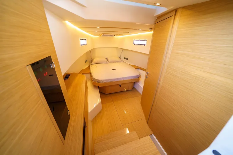 Pardo 38 Yacht Photos Pics Luxurious cabin interior of 2025 Pardo Yachts P38, featuring modern wood finishes and cozy bed.
