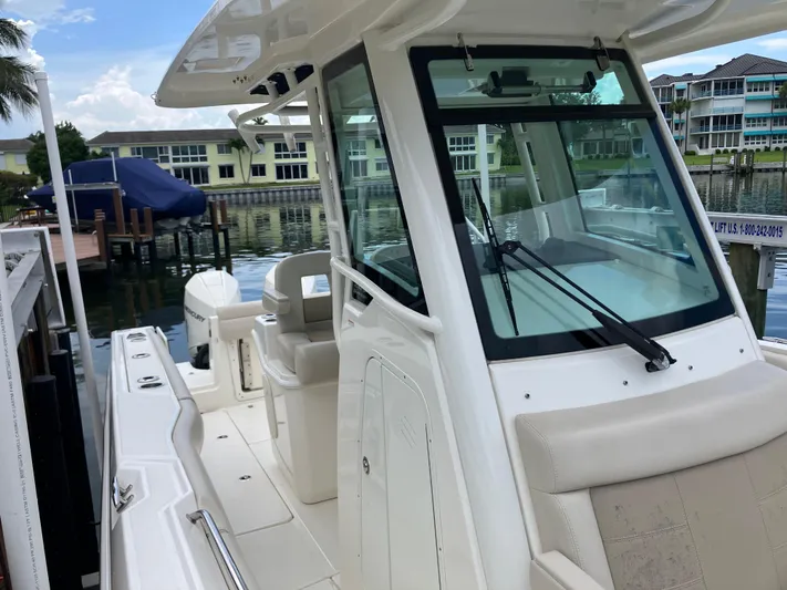  Yacht Photos Pics 2020 Boston Whaler 280 Outrage boat docked near waterfront homes.