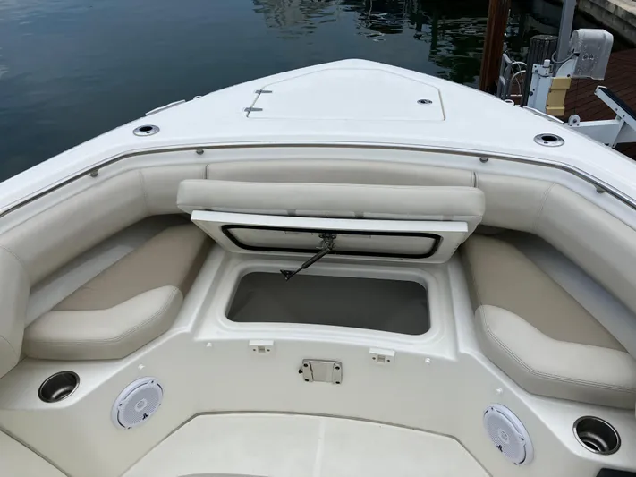  Yacht Photos Pics 2020 Boston Whaler 280 Outrage boat interior with cushioned seating and storage compartment.