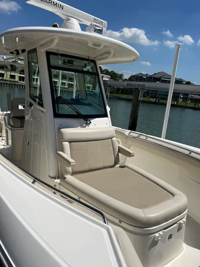  Yacht Photos Pics 2020 Boston Whaler 280 Outrage boat with seating, docked by waterfront homes.