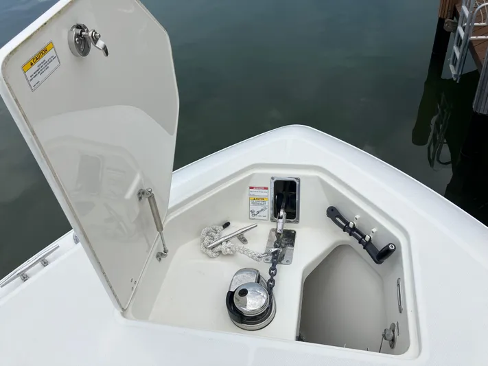  Yacht Photos Pics Anchor compartment of 2020 Boston Whaler 280 Outrage boat, open hatch, dockside view.