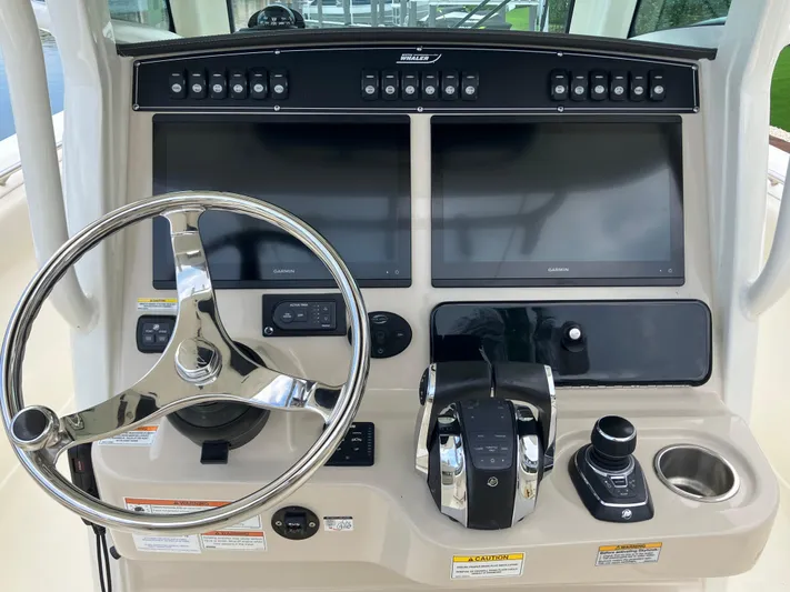  Yacht Photos Pics Control panel of a 2020 Boston Whaler 280 Outrage boat with dual screens and steering wheel.